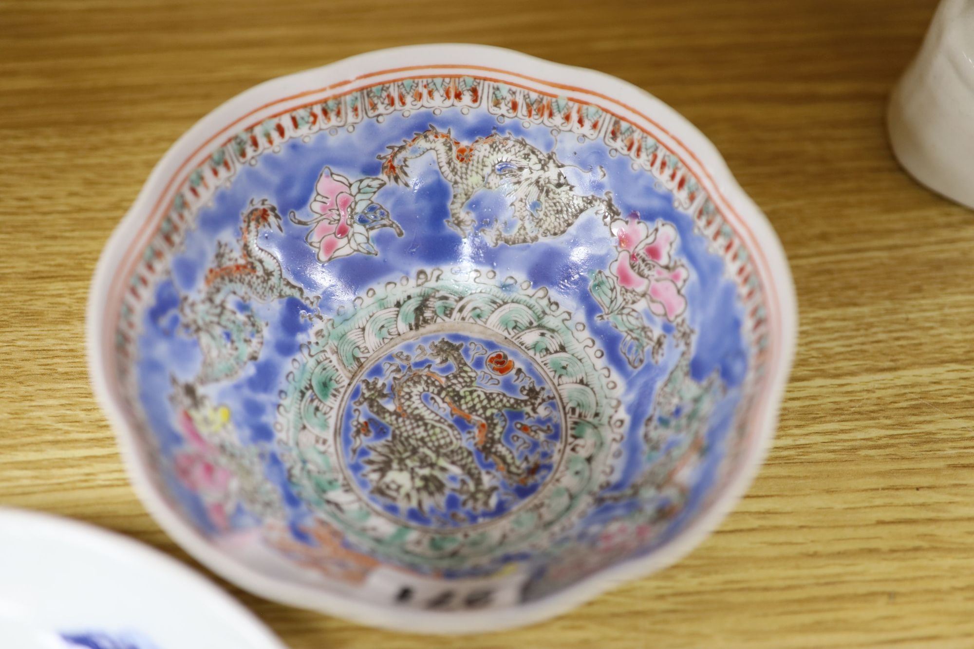 A quantity of Chinese and Japanese ceramics, including a blue and white dragon dish, a Cantonese famille rose dish, four cloisonne pi